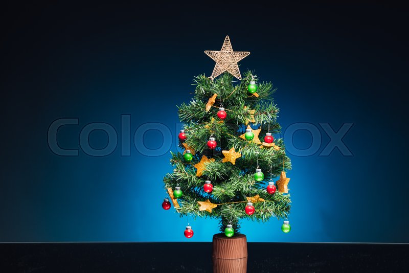 Festive Christmas tree on blue | Stock image | Colourbox