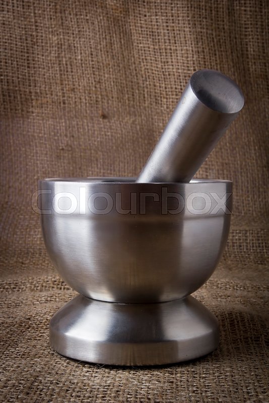 Metal mortar and pestle on burlap Stock image Colourbox