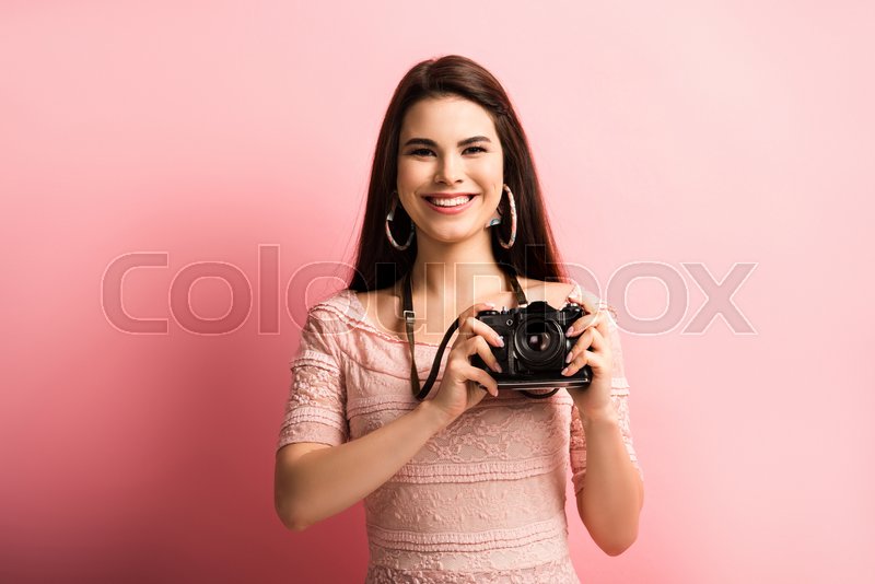 Happy photographer smiling while Stock image Colourbox