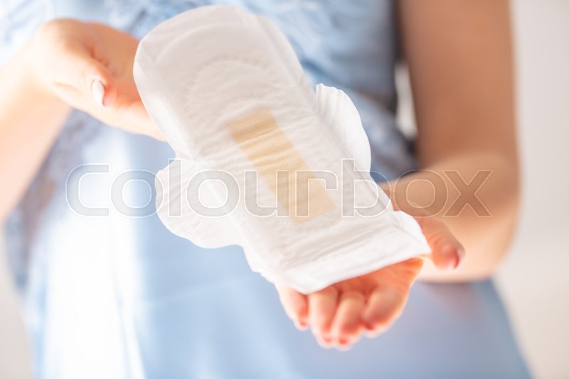 Young woman holding menstrual pad. ... | Stock image | Colourbox