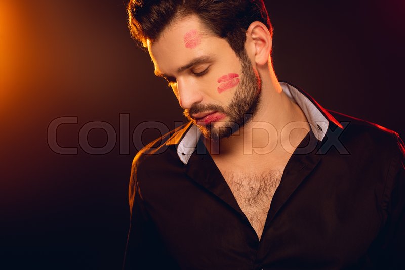 Handsome man with red lipstick prints ... | Stock image | Colourbox