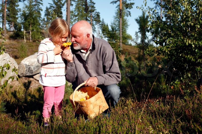 Download Little Girl And Her Grandpa Sniffing At Stock Image Colourbox