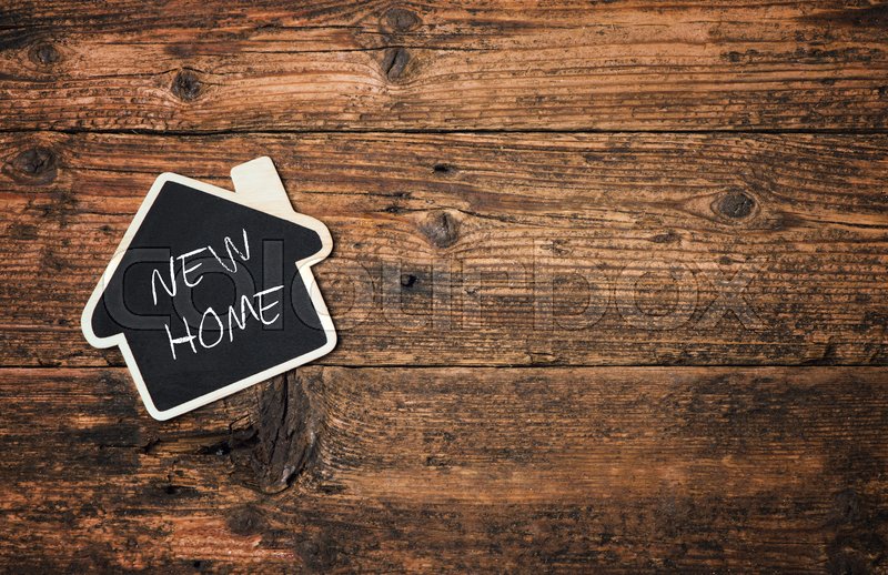 House shaped chalkboard over wooden Stock image Colourbox