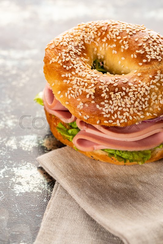 Fresh delicious bagel with sausage near Stock image Colourbox