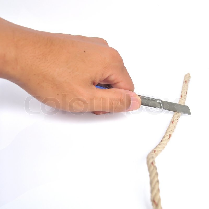 A hand holds a rope, utility knife cuts ... | Stock image | Colourbox
