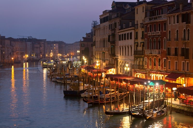 vertical oriented image of gondola passing on small canal