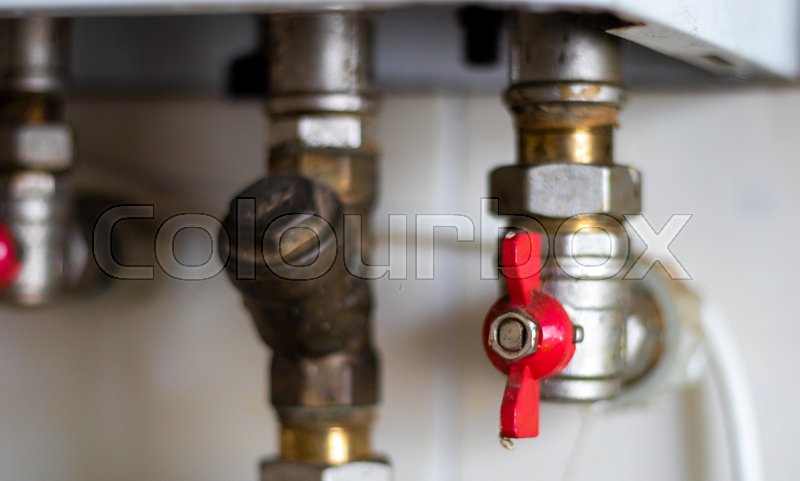 Hidden water taps for connecting a gas boiler on a tiled wall. Plumbing  connections for a