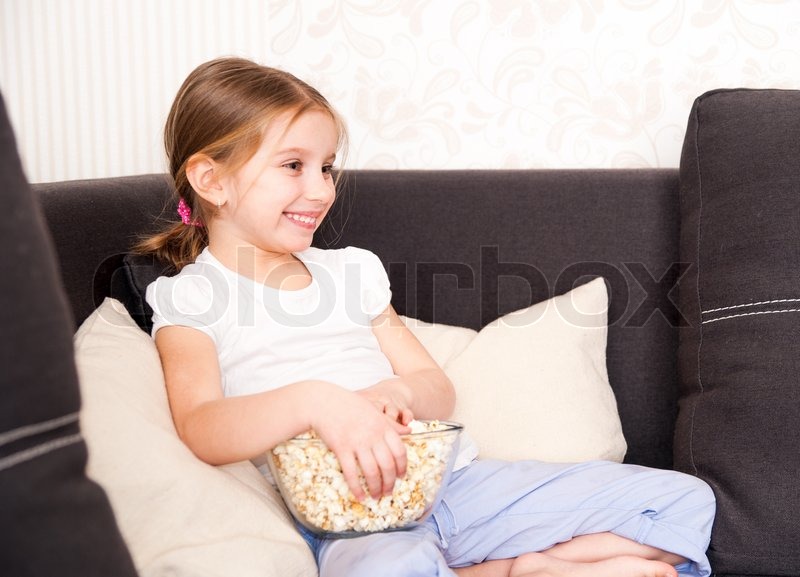 smiley little girl holding popcorn stock image smiley little girl holding popcorn stock image