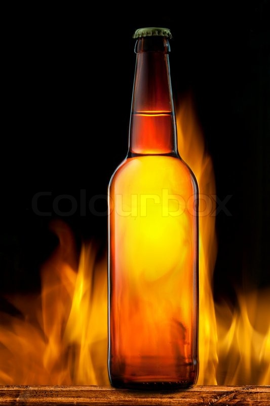 Beer bottle in fire on black Stock foto Colourbox