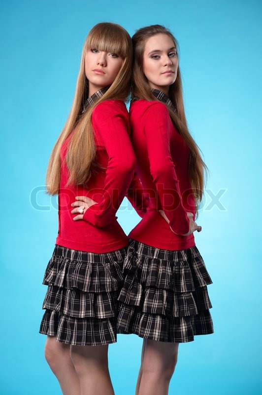 Two Teen Schoolgirls Stand Back To Back Over Blue Background Stock Photo Colourbox Two Teen Schoolgirls Stand Back To Back Over Blue Background Stock Photo Colourbox