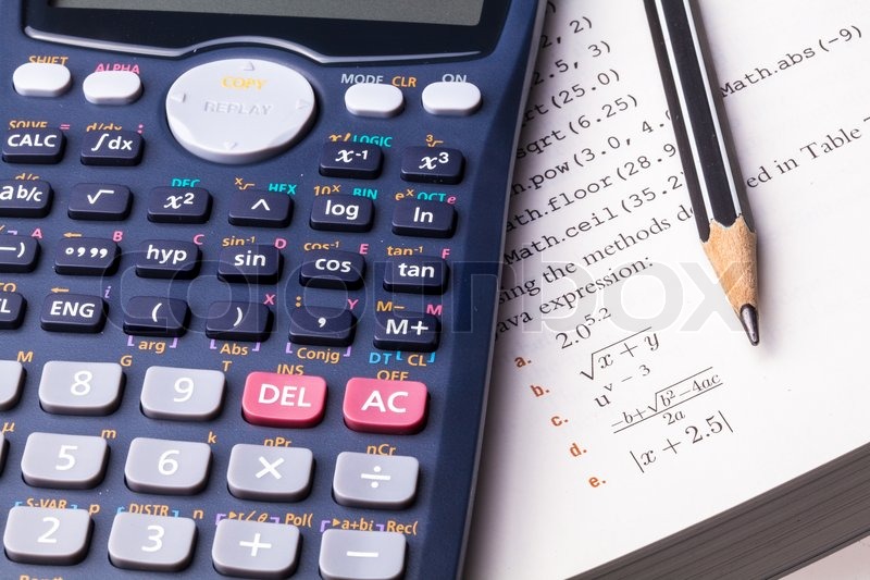 Calculator place on text book Stock image Colourbox