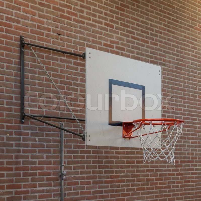 Basketball hoop on an oldbrick wall, Stock image Colourbox