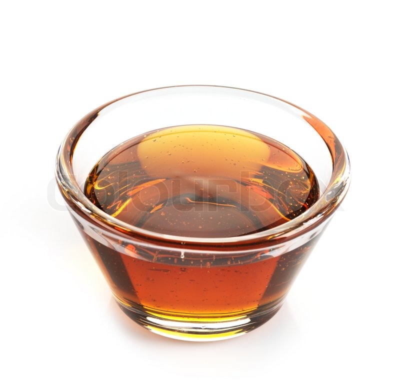 Maple syrup in a bowl on white Stock image Colourbox
