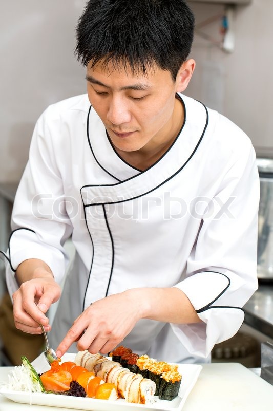 Japanese chef with a plate of sushi | Stock Photo | Colourbox