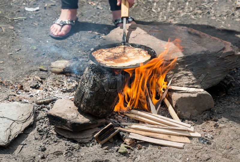 Cooking pancake on the campfire Stock image Colourbox
