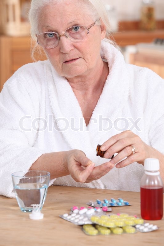 older woman taking medicine