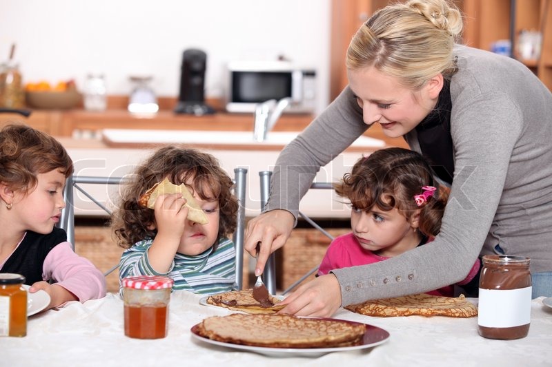 Mother preparing breakfast for kids | Stock image | Colourbox