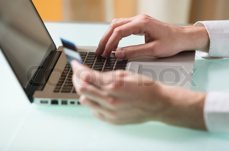 Man's hand entering data using laptop ... | Stock image | Colourbox