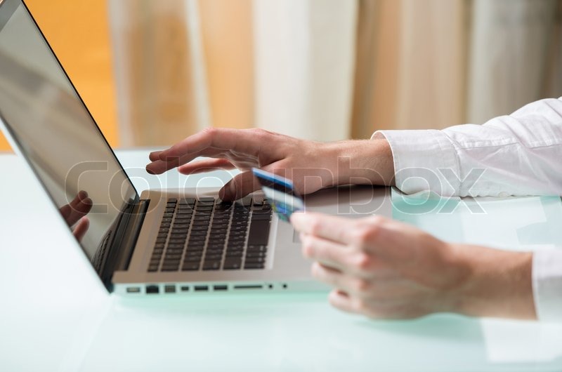 Man's hand entering data using laptop ... | Stock image | Colourbox