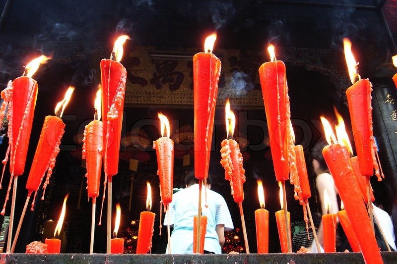 Joss sticks and red candles burning at ... | Stock image | Colourbox