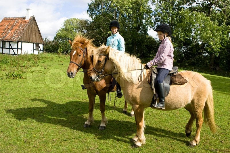 Two teenage girls riding their horses | Stock Photo | Colourbox