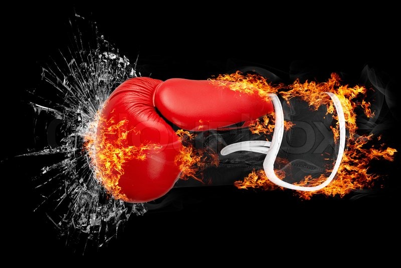 Red punching boxing glove in fire isolated on dark background punching