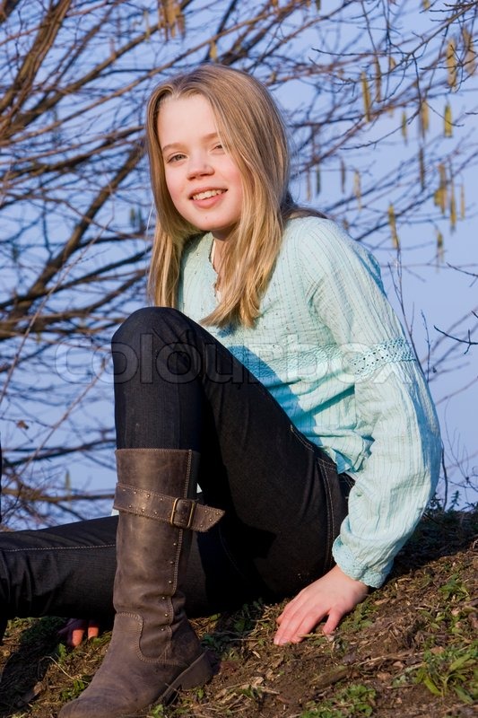 A smiling teenage girl with boots on | Stock Photo | Colourbox